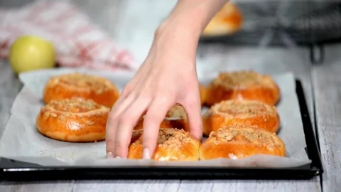 Baked apple buns freshly made ready to eat on a baking sheet for food content Stock Footage 310052179