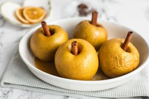 Baked apple with cinnamon stick Stock Photos