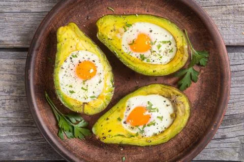 Baked avocado with eggs Stock Photos