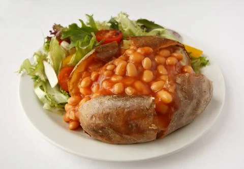 Baked bean jacket potato with side salad Stock Photos