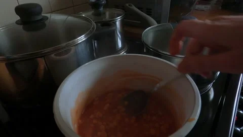 Baked beans being stirred in white pan Stock Footage 141589449