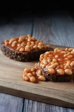 Baked beans on dark seeded bread slices Stock Photos
