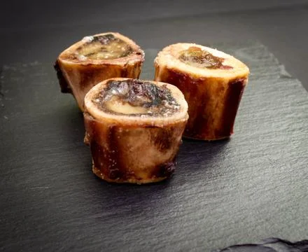 Baked beef brain bones on a dark background Stock Photos