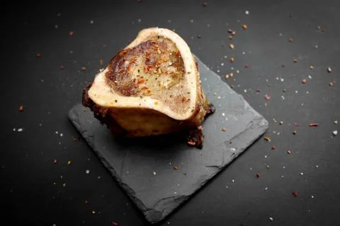 Baked beef brain bones on a dark basalt background Stock Photos