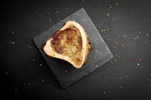 Baked beef brain bones on a dark basalt background Stock Photos