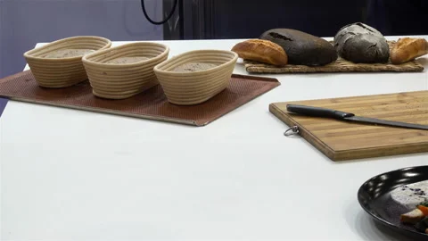 Baked bread and rolls in tins and on a cutting board in 4K. Stock Footage 139866442