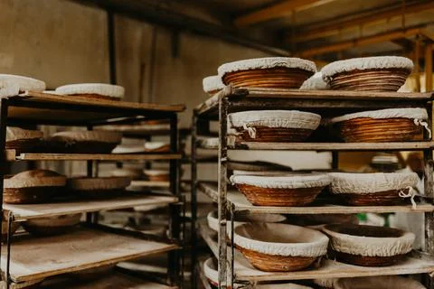 Baked bread in basked over kitchen background Stock Photos