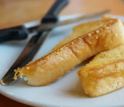 Baked bread with butter Stock Photos
