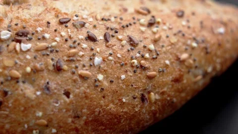 Baked bread crust covered with mixed seeds Stock Footage 330941699