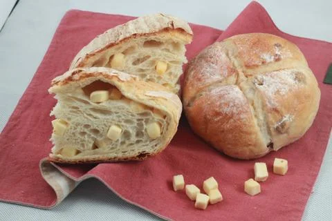 Baked bread on red tablecloth on the table in restaurant Stock Photos