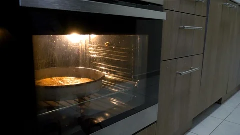 The baked bread is removed from the oven 스톡 동영상 128715375