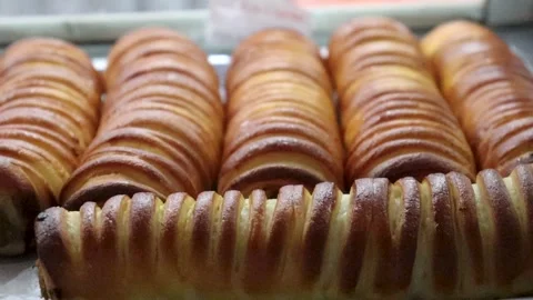 Baked bread rolls close up footage highlighting ribbed surface Stock Footage 338164541