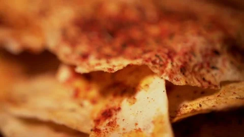 Baked bread snacks with spices and tomatoes on wooden cutting board, close-up Stock Footage 83425715