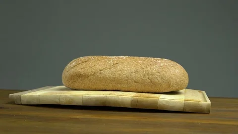 Baked Bread on Wooden Table, Isolated Grey Background, Slider Stock Footage 76521876