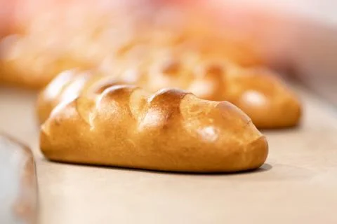 Baked breads on automatic production line bakery from hot oven Stock Photos