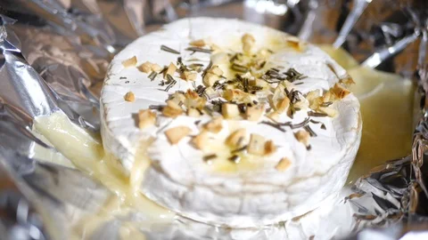 Baked Camembert, being dipped with bread in slow motion. Stock Footage 109533424