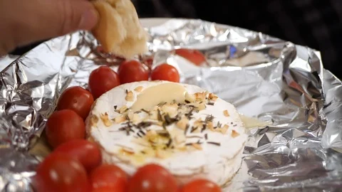 Baked Camembert, being dipped with bread in slow motion. Stock Footage 109533636