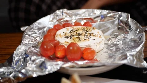 Baked Camembert, being dipped with bread in slow motion. Stock Footage 109533645