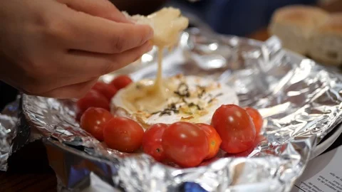 Baked Camembert, being dipped with bread in slow motion. Stock Footage 109533688
