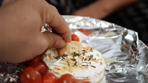 Baked Camembert, being dipped with bread in slow motion. Stock Footage 109533787
