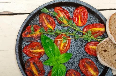 Baked cherry tomatoes with basil and thyme Stock Photos