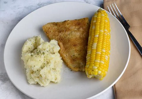 Baked cod  with corn and mashed potatoes Stock Photos