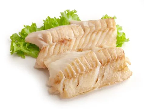 Baked cod loin with lettuce Stock Photos