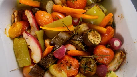 Baked cooked fresh vegetables fruit herbs on ceramic baking sheet. Stock Footage 312464036