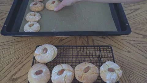 Baked cookies appear on the cooling rack from cookie sheet. The process of Stock Footage 169795479