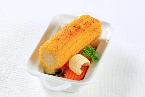 Baked corn in a plastic takeout container Fotos de archivo