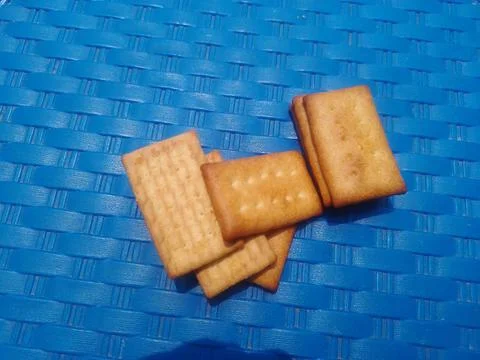 Baked Crackers on Blue Surface. 스톡 사진