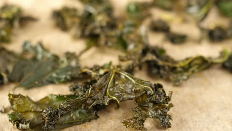 Baked curly kale chips crispy dry dried leaves healthy trendy snack Stock Footage 137693585