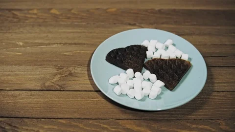 Baked dark waffles in shape of heart on the plate, romantic dessert. Stock Footage 100191217