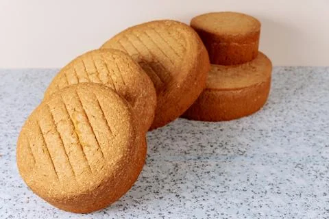 Baked different sizes sponge cakes on table for making wedding cake. Stock Photos