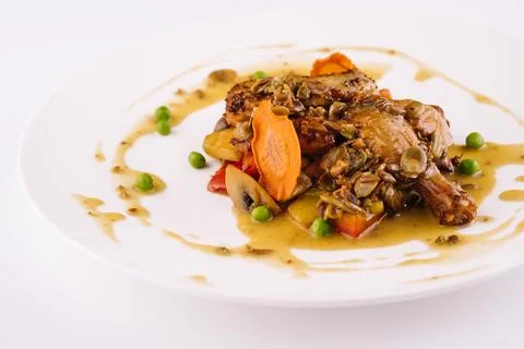 Baked duck leg in sauce with vegetables Stock Photos