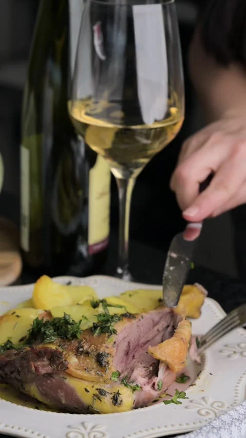 Baked duck in a serving plate with a side dish and a glass of wine. Women's Stock Footage 267104583