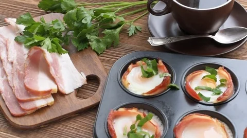 Baked eggs with bacon in muffin tin. Stock Footage 69939251
