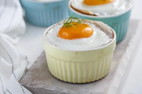 Baked eggs in ramekins close view, selective focus Stock Photos