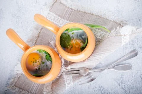Baked eggs with spinach Stock Photos