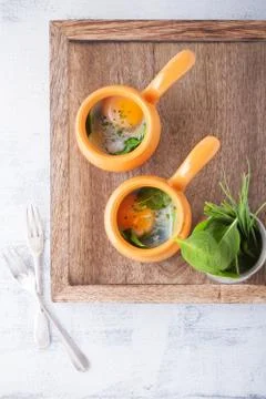 Baked eggs with spinach Stock Photos