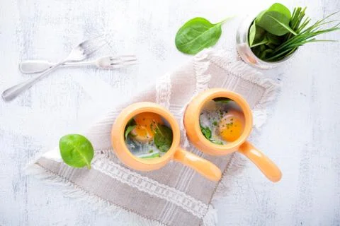 Baked eggs with spinach Stock Photos