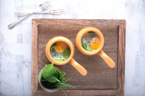 Baked eggs with spinach Stock Photos