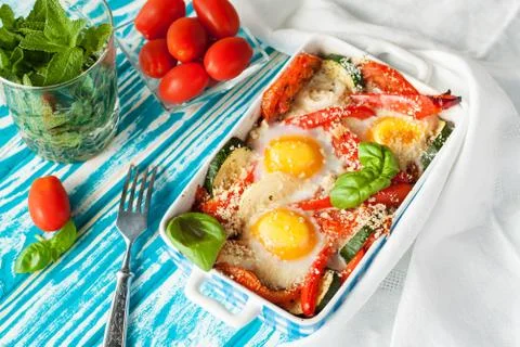Baked eggs with vegetables Stock Photos
