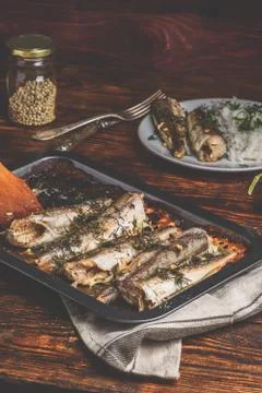 Baked fish carcasses on baking sheet Stock Photos