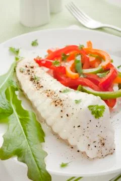 Baked fish dinner vertical Stock Photos
