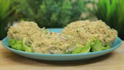 Baked fish muffins plated and served on a dish with fresh lettuce leaves Stock Footage 340553112