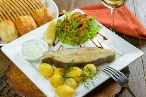 Baked fish with potatoes Stock Photos