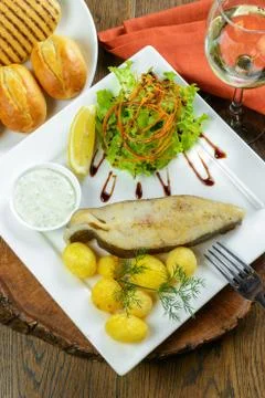 Baked fish with potatoes Stock Photos