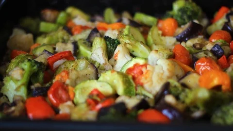 Baked fresh vegetables lie on the baking sheet Stock Footage 107932341