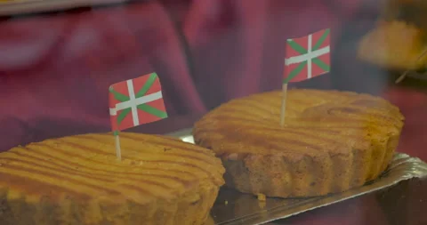 Baked goods with the Basque flag and chocolate croissants on display in a bakery Stock Footage 143465994